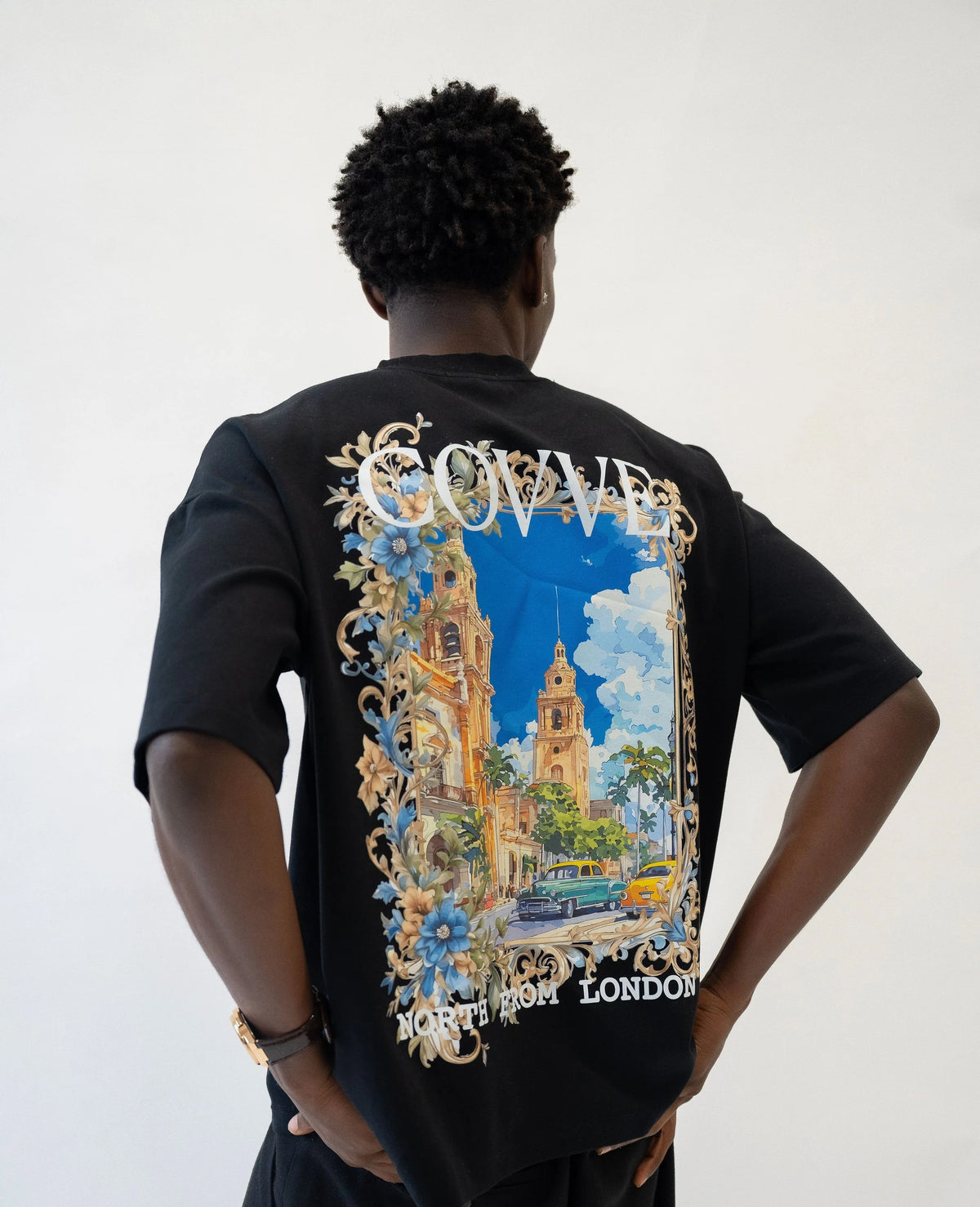 Model seen from behind wearing the black City Bloom oversized T-shirt with the large COVVE North From London back print