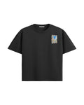 Black City Bloom oversized T-shirt, front view with a small city-scene print on the left chest