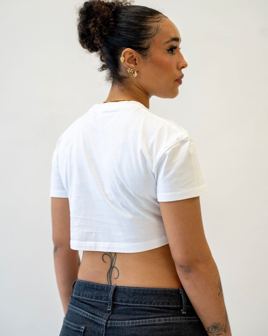 Model wearing the White City Bloom cropped T-shirt, back view